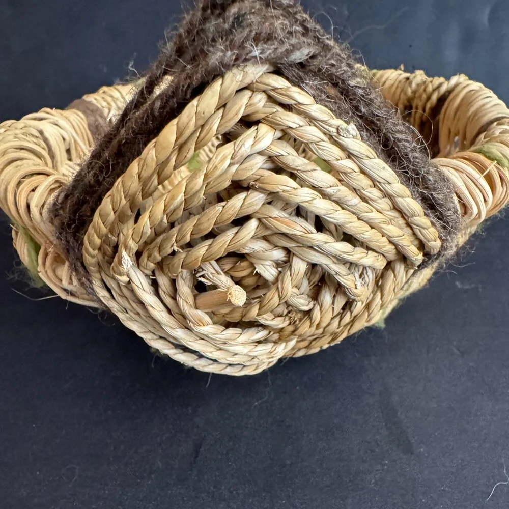 Vintage handwoven basket with brown and green yarn details and eye of God.
